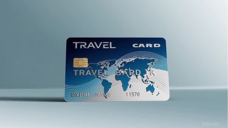 A blue travel credit card featuring a world map design displayed upright against a light background.