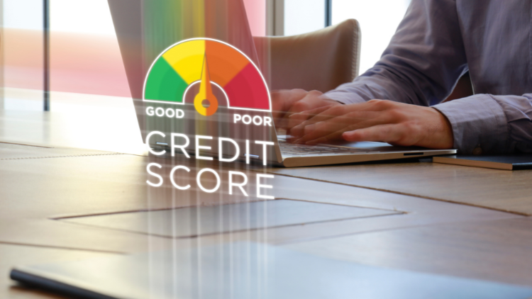 A person types on a laptop with a credit score gauge overlay, symbolizing how starter business credit cards help improve credit scores.