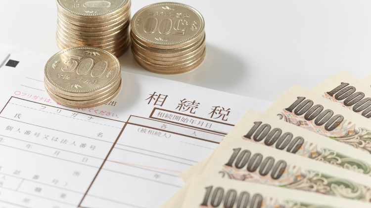 Japanese yen coins and bills placed on a tax document, symbolizing the costs and fees tied to business credit cards.