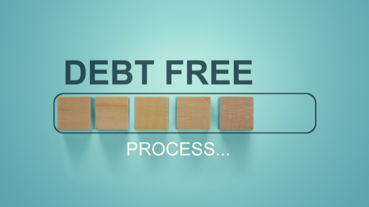 Wooden blocks form a progress bar under the words “Debt Free Process,” symbolizing the journey to financial freedom.